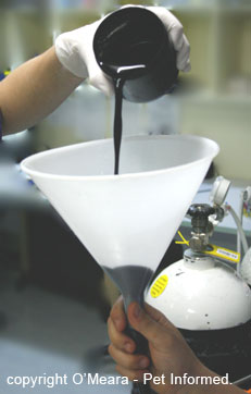 This is a mixture of charcoal powder and water being poured into the gastric lavage tube's funnel at the end of a gastric lavage procedure.